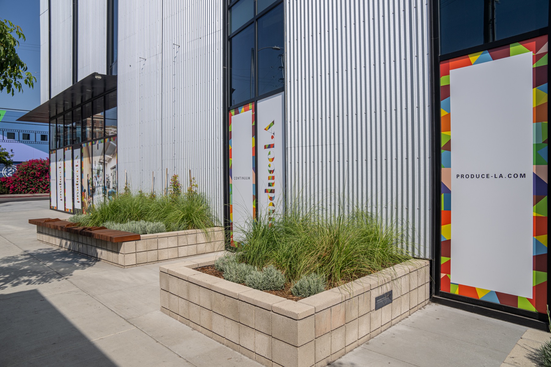 Landscaped sidewalk and ground floor windows of the completed building