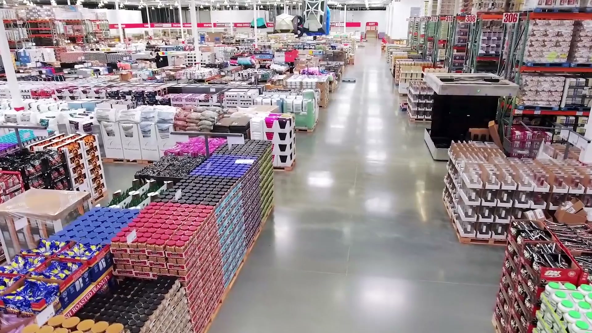 Elevated view traveling through a Costco interior with merchandise aisles and warehouse shelving