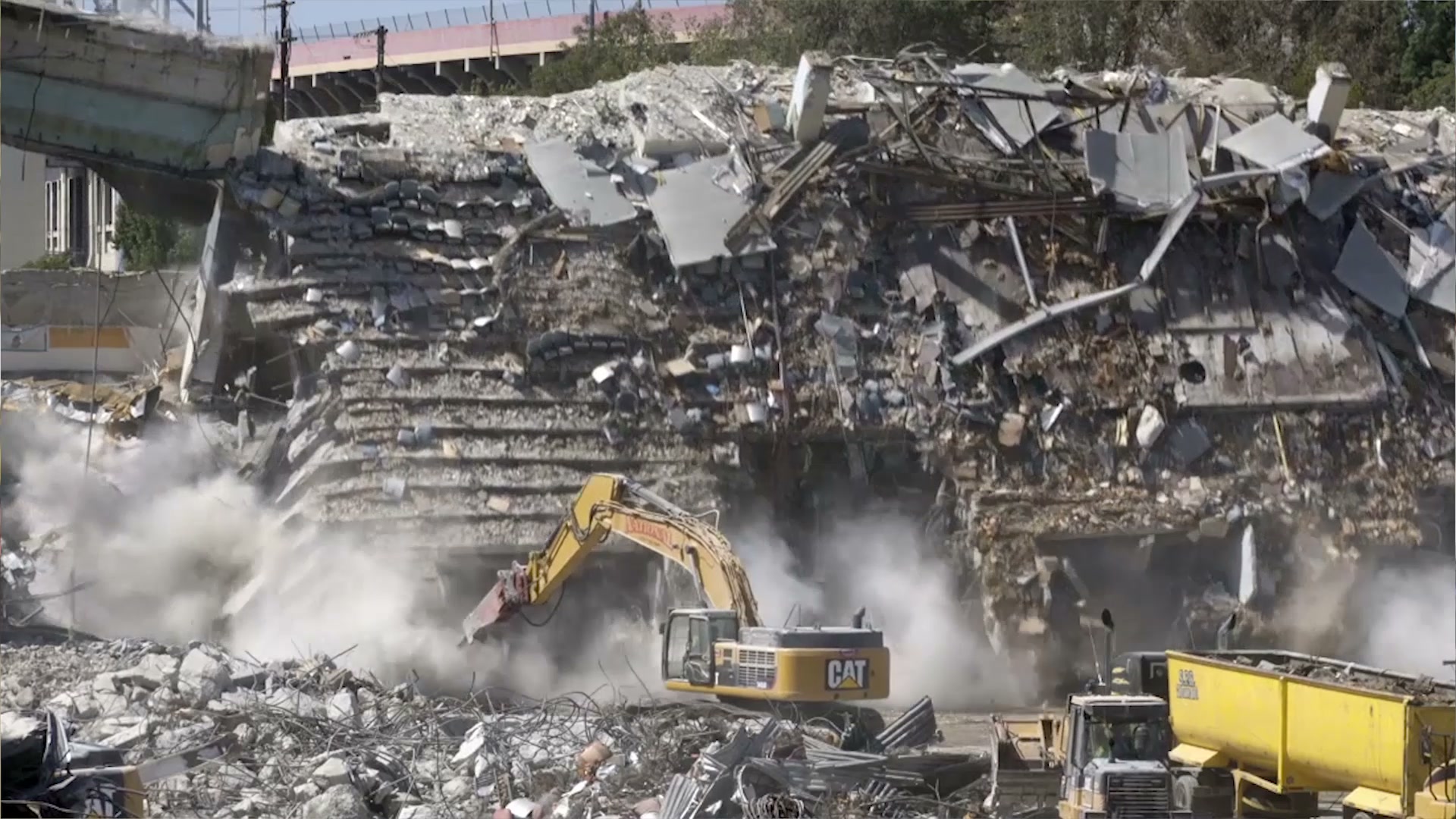 Excavator demolishing the old arena’s concrete seating